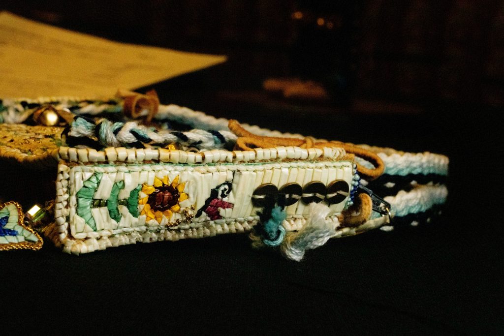 View of the side of the tiny purse. Beadwork includes a tiny Sunflower.